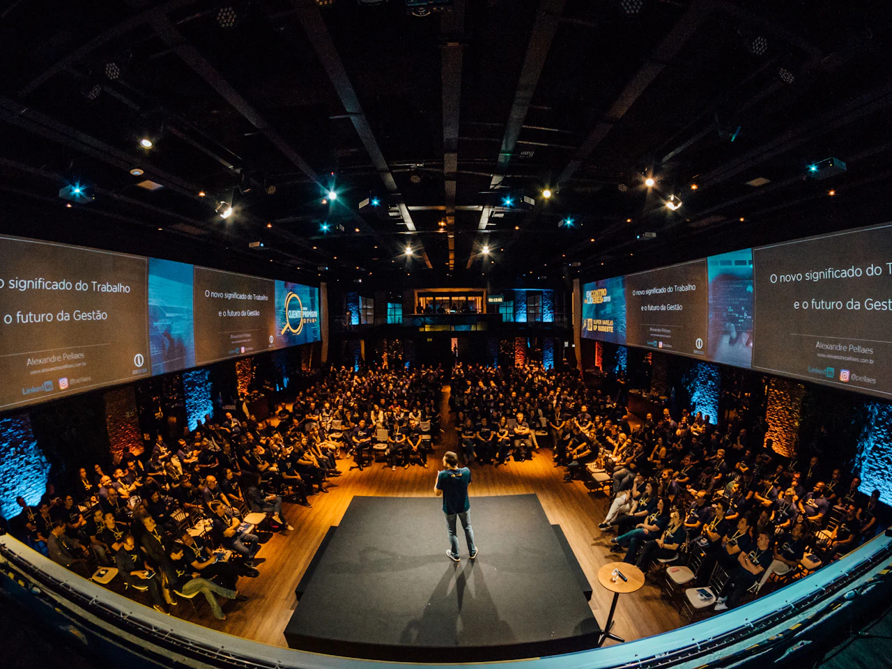 An audience gathered in a conference hall for a presentation.